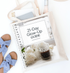 This is a mockup of our 21-day glow-up guide as a binder. It sits on top of a tote bag filled with a tablet and wine bottle on a table with a pair of shoes.