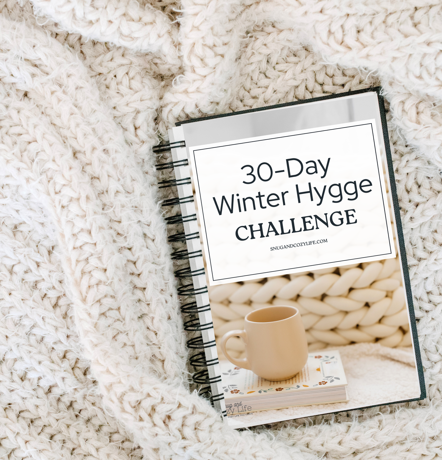 This is a mockup of the 30-day winter hygge challenge printable guide sitting on a cozy knit blanket.